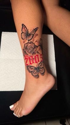 a woman's leg with butterflies and roses on it, while the word zoo is written in red ink