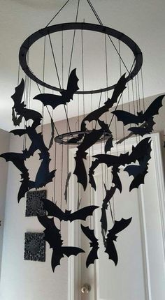 a wind chime with bats hanging from it's centerpiece in a room