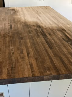 a wooden counter top in the middle of a kitchen