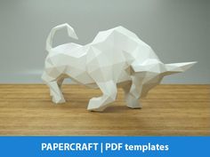 an origami rhinoceros standing on a wooden floor