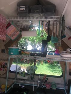 the inside of a camper with pots and pans hanging from it's ceiling