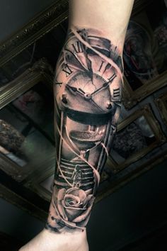 a man's arm with a clock and rose tattoo design on the left forearm