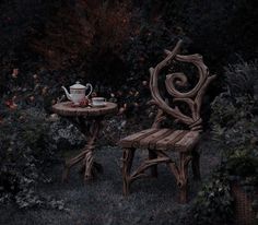 two wooden chairs sitting next to each other in the grass