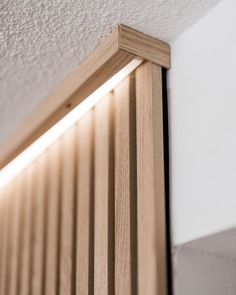 a close up of a light that is on the side of a wooden door frame