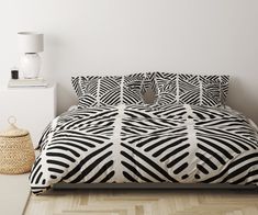 a bed with black and white patterns on it