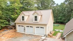 an overhead view of a two car garage in the middle of a yard with trees