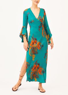 This Rita Green Floral Print Maxi Dress is stylish and unique, crafted with an exclusive green orchid floral print, v-neck design, and flutter sleeves. Enjoy the side slits and elegant one of a kind style all summer long. Make a statement with this chic and comfortable maxi dress. Comfortable Maxi Dresses, Resort Wear Dresses, Green Orchid, Honeymoon Outfits, Angel Sleeves, Green Floral Print, Full Length Dress, Dramatic Look, Floral Print Maxi Dress