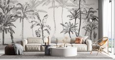 a living room with palm trees painted on the wall and furniture in front of it