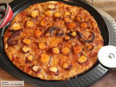 a pizza sitting on top of a pan covered in toppings