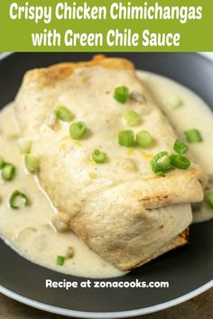 chicken chimichangas with green chile sauce in a black bowl on a wooden table