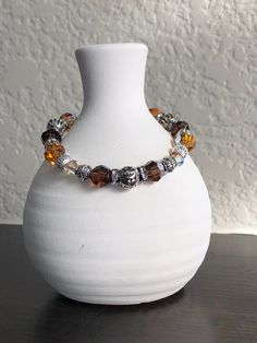 This beautiful bracelet is made with Swarovski And Czech Crystal's (smoky and brown tones with gold colored accents). It also has two different silver beads and a silver toggle closure. I can change it to a lobster clasp or a stretch bracelet if you like, just let me know! Brown Faceted Bead Bracelet, Brown Bracelet With Silver Beads, Brown Crystal Bracelet With Faceted Round Beads, Brown Silver Beads Bracelet Jewelry, Brown Silver Beaded Bracelet, Brown Crystal Bracelet With Faceted Beads For Gift, Brown Crystal Bracelet With Faceted Beads As Gift, Brown Faceted Beads Bracelets As Gift, Brown Bracelets With Faceted Beads For Gift