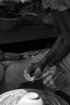 a black and white photo of a man shaving his legs