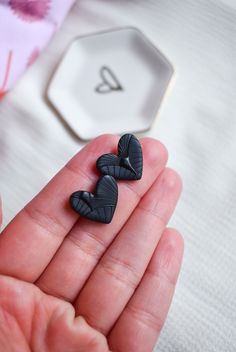 "Black Heart Stud Earrings are perfect for that Minimal Look. Beautifully textured, they are a great everyday accessory or as a jewelry gift for anyone. Handmade with Black Polymer Clay and fun texture to add depth to the design. Stainless Steel Earring posts to make them Hypoallergenic and hard to tarnish! Size: 3/4\" x 3/4\" Material: Polymer Clay, Stainless Steel Love this Style? Check out our other Styles in Shop! https://www.etsy.com/shop/DearWildflowers Super Lightweight and comfortable to Black Polymer Clay, Jewelry For Girls, Minimal Earrings, Earring Handmade, Clay Earring, Earring Gift, Earring For Women, Funky Jewelry, Earring Posts