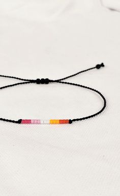 Lesbian bracelet string adjustable, Subtle lesbian jewelry, Beaded LGBTQA bracelet, Lesbian accessories, gift for lesbian best friend Adjustable Rainbow Friendship Bracelets With Letter Beads, Rainbow Resizable Beaded Bracelets For Friendship, Resizable Rainbow Beaded Friendship Bracelets, Rainbow Friendship Bracelets With Sliding Knot, Resizable Rainbow Friendship Bracelets, Rainbow Adjustable Cord Friendship Bracelet As Gift, Adjustable Round Beads Friendship Bracelet For Best Friend, Rainbow Jewelry With Sliding Knot For Gift, Rainbow Sliding Knot Bracelet As Gift