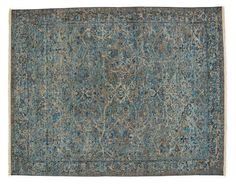 an antique rug with blue and grey colors on the ground, in front of a white background