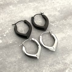 Add a touch of whimsy to your look with our unique pointy hoop earrings . These earrings are perfect for adding a playful yet sophisticated touch to any outfit. Sold as pair Material : 316 Stainless steel Hoop inner diameter: 12 mm Hoop thickness: 4 mm Hoop length: 20 mm Closure: Snap up closure Listing for pair of hoops only Gothic Earrings, Cuff Rings, Men Earrings, Earring Sale, Gothic Jewelry, Ring Necklace, New Shop, Black Silver, Ear Cuff