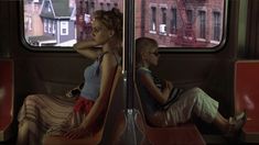 two women sitting on a bus looking out the window