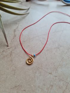 🌙 Handcrafted 14k gold plated dainty adjustable red string necklace 🌙 All materials used are tarnish free and durable 🌙 Best gift for your friends and family or just for yourself 🌙 Regular shipping takes approximately 10-15 business days depending on your country. Express shipping takes 3-5 business days. Please choose express shipping if you want to receive your package faster 🌙 I do offer combined shipping. Please feel free to contact me for custom orders and combined shipping orders 🌙 Although my products are durable and tarnish free, you better keep them away from excessive water and chemicals, perfumes etc. 🌙 For more jewelries don't forget to check my store: https://www.etsy.com/shop/MiniMoonDesign Handmade Adjustable Yellow Gold Charm Necklaces, Spiral Adjustable Necklace As Gift, Adjustable Spiral Necklace As Gift, Adjustable Spiral Necklace For Gifts, Adjustable Spiral Necklace For Gift, Adjustable Charm Necklaces With Tiny Beads As Gift, Adjustable Tiny Beads Charm Necklace As Gift, Red Spiral Jewelry As Gift, Red Spiral Jewelry For Gifts