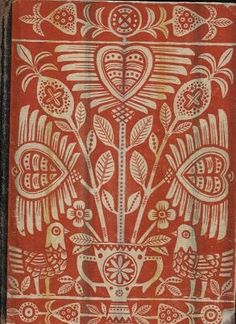 an intricately designed red and yellow book with birds on it's front cover