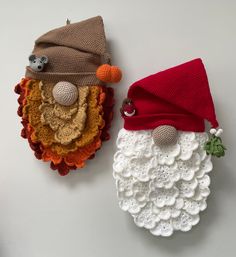 two crocheted santa and mrs claus hats on top of each other, one wearing a red hat