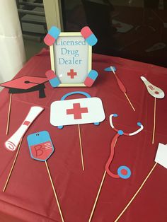 a red table topped with medical items on sticks