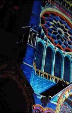 a clock tower with intricate designs on it's side