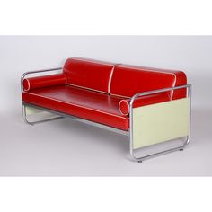 a red and white couch sitting on top of a metal frame