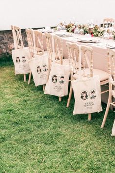 a long table is set up with chairs and place settings for an outdoor wedding reception