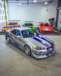 several cars parked in a garage next to each other