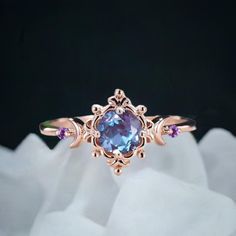 a ring with an oval blue topaz surrounded by purple stones