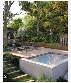 an outdoor swimming pool surrounded by greenery and wooden steps leading up to the deck