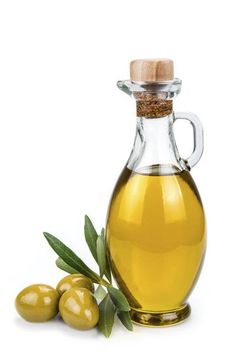 an olive oil bottle next to some green olives