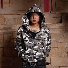 The Camo Zip-up Embroidery Hoodie is a striking blend of street style and military influences, making it a standout piece in any wardrobe. This hoodie features an all-over black-and-white camouflage print, contrasted by acid symbol motifs embroidered on the left side of the body and sleeve, adding an edgy, rebellious touch. The hoodie is designed with a central zipper for easy wear, and it includes practical pockets near the hem. The ribbed cuffs and hem provide a snug fit, while the cropped sil Sneakers And Socks, Embroidery Hoodie, Half Shirts, Jean Accessories, Camouflage Print, Bold Fashion, Easy Wear, Zip Up, Short Pants