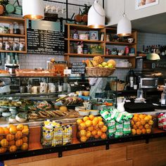 a counter with oranges and other foods on it in a restaurant or bar area