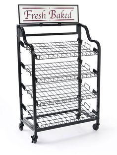 a metal rack with four trays on wheels and a sign that reads fresh baked