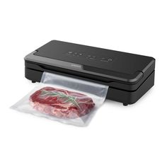 a piece of meat in a plastic bag on top of a printer with the lid open