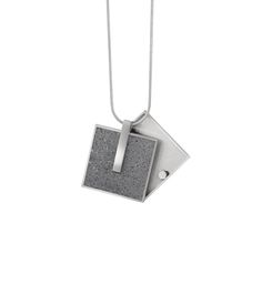 Handcrafted minimalist geometric design elegantly suspends from a polished stainless steel snake chain. Lockets feature a pivoting fascia fastened by rare earth magnets securing your keepsake—a photo, loving note, or lock of hair—inside a hidden compartment. Uniquely personalize your Memento with the cremains of a loved one—man, woman, child, or pet—cast into natural (grey) concrete. When you place your order with the cremains option we will automatically email FAQs for your reference. If you ha Wearable Architecture, Concrete Necklace, Concrete Pendant, Lock Of Hair, Concrete Jewelry, Magnetic Jewelry, Hair Locks, Rare Earth Magnets, Jewellery Design