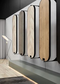 three wooden surfboards are hanging on the wall