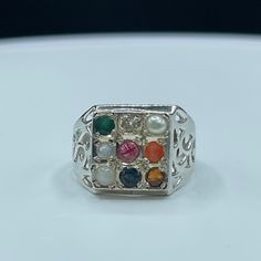 This Is A Beautiful Multi Gemstone Chakra Sterling Silver Ring That Is Size 9. This Ring Features The Following Gemstones; Hessonite, Sapphire, Moonstone, Carnelian, Ruby, Aquamarine, Pearl, Topaz, & Emerald. The Deck Of The Ring Measures Approximately 13.7 Mm. This Ring Is Also Stamped 925 For Sterling Silver. This Ring Is Handmade And It Is Unisex. This Ring Is New And Unworn. White Fusion Style Gemstone Ring, Spiritual Multicolor Multi-stone Rings, Multicolor Round Gemstones With Stone Setting, White Multi-stone Sterling Silver Birthstone Ring, Spiritual Silver Multi-stone Gemstones, White Multi-stone Fusion Jewelry, White Fusion Multi-stone Jewelry, White Fusion Style Multi-stone Jewelry, Unisex Ring