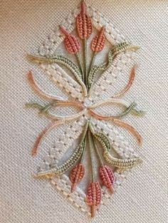 a close up of a piece of cloth with flowers embroidered on the front and back