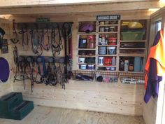 the inside of a shed with lots of horse tacks