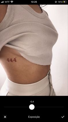 a woman's stomach with the word aa tattooed on her lower back and side