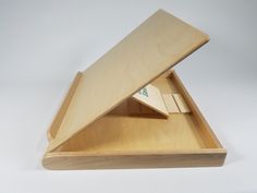 an open wooden box with two pieces of wood in the bottom and one piece missing