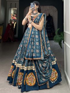 Elevate your traditional Indian festival look with our breathtaking blue bandhani printed rayon navratri lehenga choli! Crafted from high-quality rayon material, this stunning lehenga features a mesmerizing Gamthi Patch Work with delicate lace touch-ups for an elegant finish. The iridescent blue hue of the lehenga will surely make you the center of attention at any Navratri celebration.
The set includes a matching choli embellished with Gamthi Patch Work and lace detailing, along with a bandhani Traditional Sharara With Kalamkari Print For Navratri, Blue Semi-stitched Bohemian Sets, Bohemian Blue Semi-stitched Sets, Unstitched Blue Bohemian Sets, Unstitched Bohemian Sets In Blue, Blue Bohemian Unstitched Sets, Blue Bohemian Sets Unstitched, Blue Semi-stitched Bohemian Sharara, Blue Bohemian Sharara With Dupatta