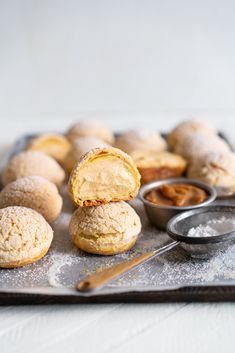 several pastries on a baking sheet with powdered sugar and peanut butter in the middle