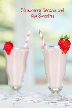 two glasses filled with strawberry banana and kiwi smoothie next to each other on a table