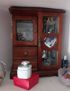 a wooden cabinet sitting next to a red box