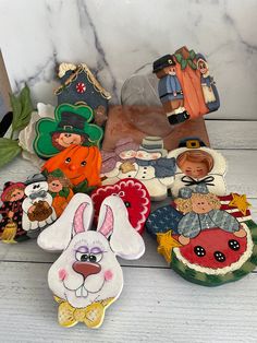 several small christmas ornaments on a white table