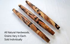 four wooden dowks are lined up next to each other on a white surface with the words all natural hardwoods grains vary in each sold individually