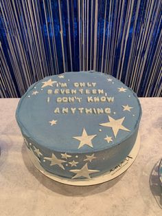 a blue cake with white stars on it and the words i'm only seventh, i don't know anything